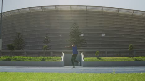 front view of african american athlete throwing javelin