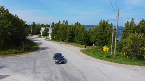 Cinematic-aerial-b-roll-moving-from-coastal-road,-revealing-lake-huron