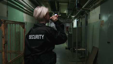 female safety guard with flashlight in a warehouse