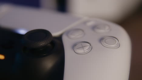 ps5 controller in an rgb led room at night, fast pan close-up