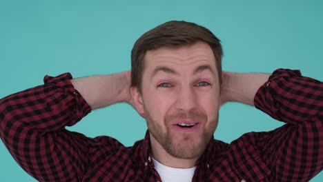 the americanlooking actor is very surprised and says wow. the american-looking actor is very surprised and says wow. surprise. wide open mouth and big eyes. guy in the studio on a blue