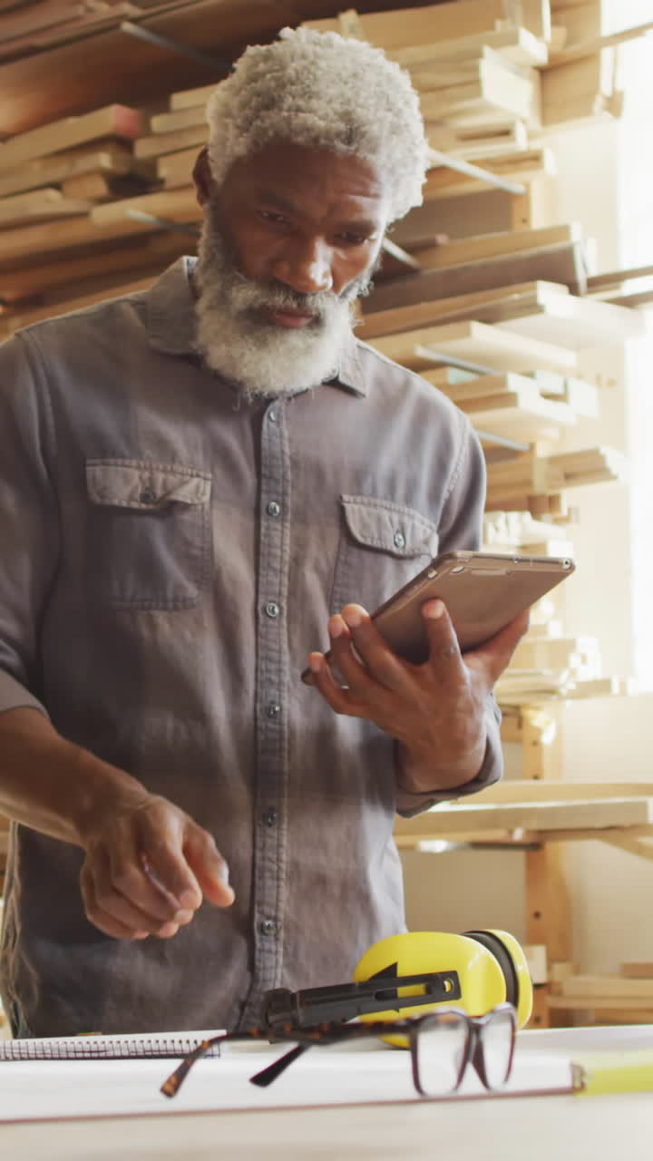 African American man in a woodworking workshop, with copy space