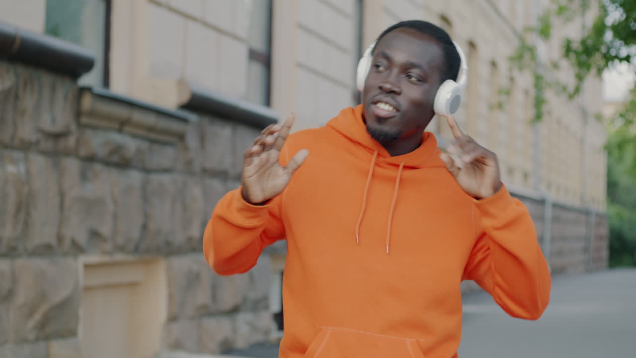 Man Dancing to Music on the Street