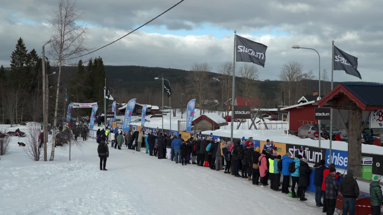 Cross Country Skiers Arriving at a Stop at Worlds Largest Cross Country Ski Race Vasaloppet, Establishing shot