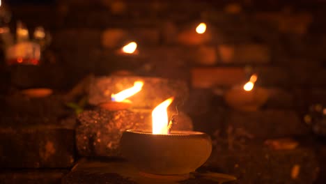 close up of traditional stone candles burning during yi peng festival in thailand