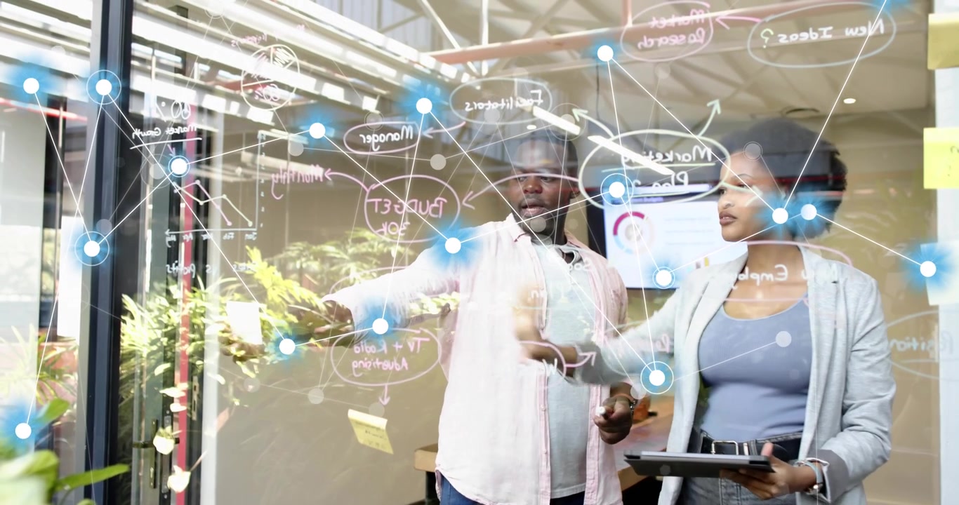 Man pointing tablet initiating blue nodes on glass while woman dragging nodes for business planning