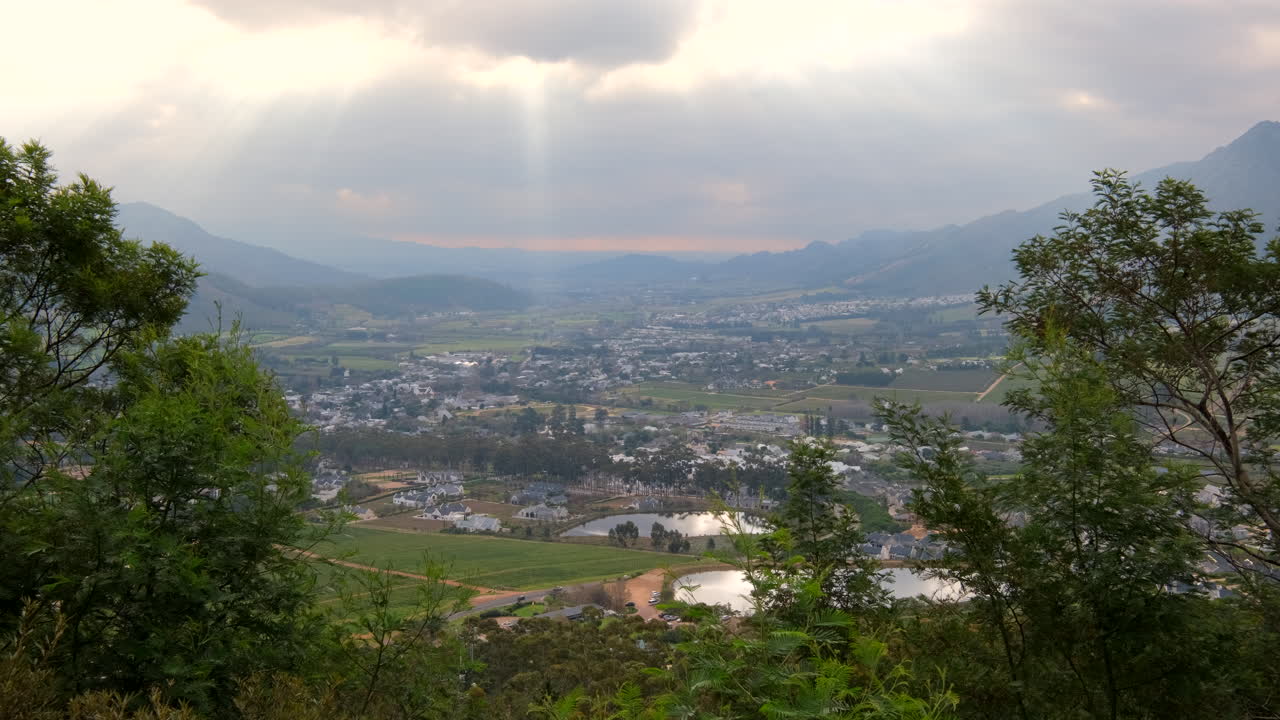 High mountain pass view over Franschhoek wine valley with god rays from sky