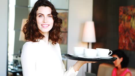 waitress holding tray in restaurant