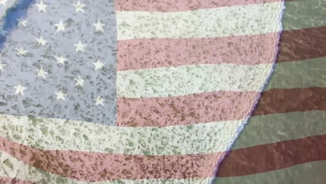 Digital-composition-of-waving-us-flag-against-aerial-view-of-the-beach-and-sea-waves