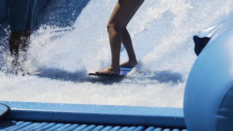 surfing wave machine, close up on feet