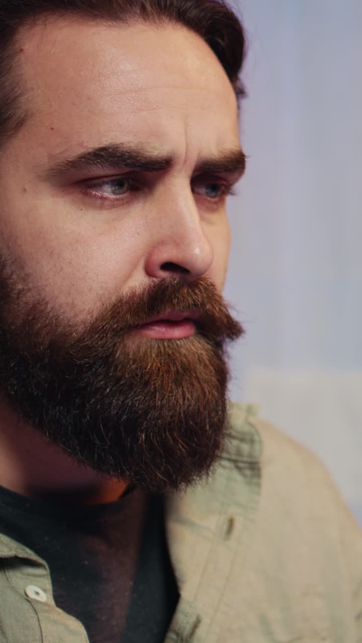 Close-up of Thoughtful Man with Beard Looking Around