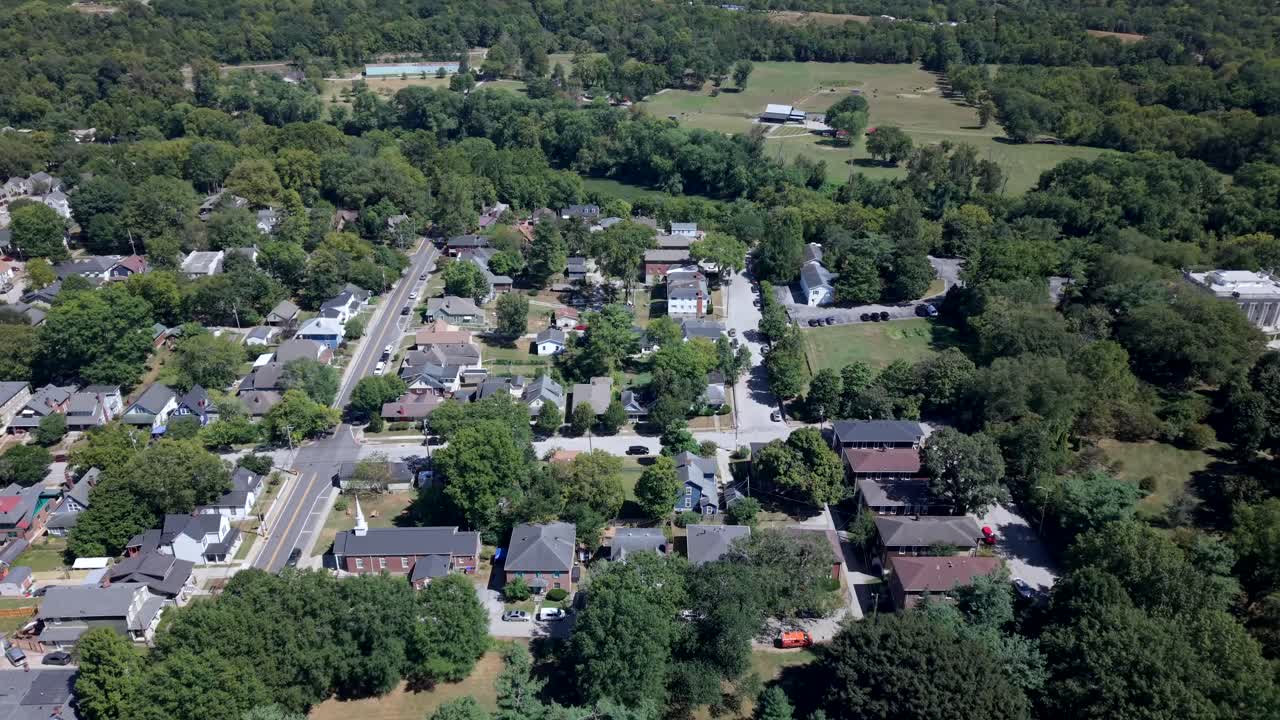 Rural neighborhood in Kentucky near Lexington - tilt down aerial flyover in on a sunny day