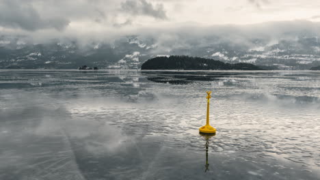 frozen lake in a foggy winter day in norway - timelapse