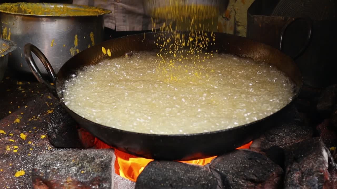 Indian street food. Boondi or Bundiya is an Indian dessert made from sweetened, fried chickpea flour. Being very sweet, it can only be stored for a week or so. Rajasthan state in western India.