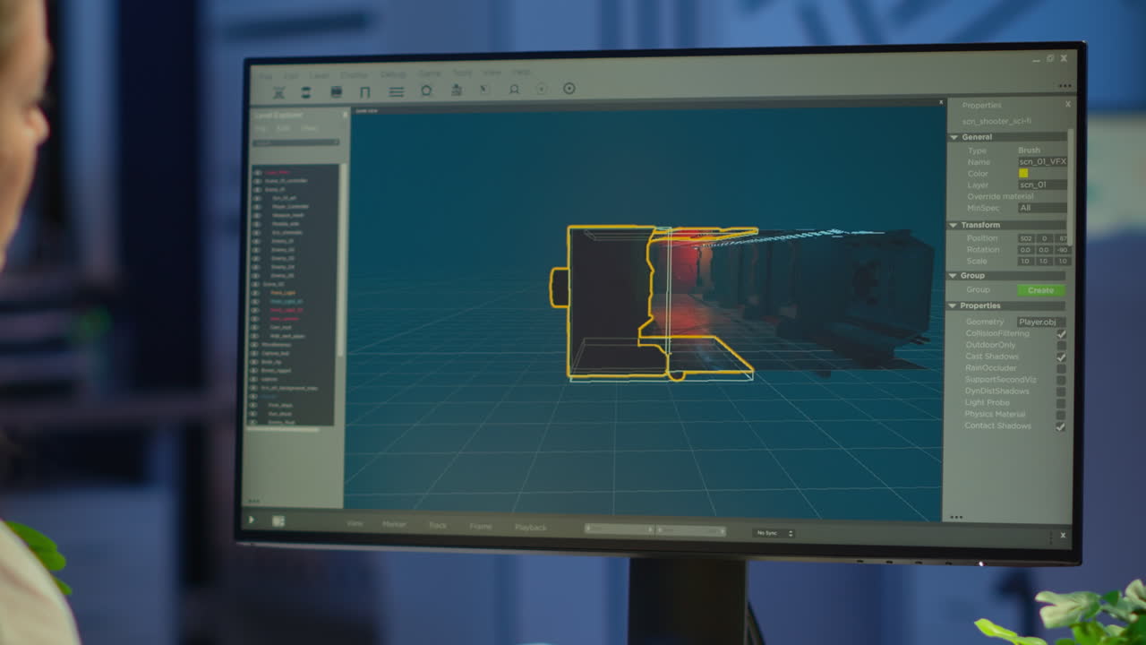 Woman game designer looking at computer screen working late night