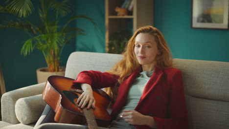 girl looking at camera with a guitar