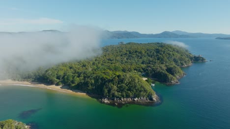 Aerial-view-of-remote-Ulva-Island-and-Paterson-Inlet,-part-of-Stewart-Island-Rakiura-in-the-south-of-New-Zealand-Aotearoa,-with-sandy-beaches,-blue-ocean-and-tree-covered-landscape