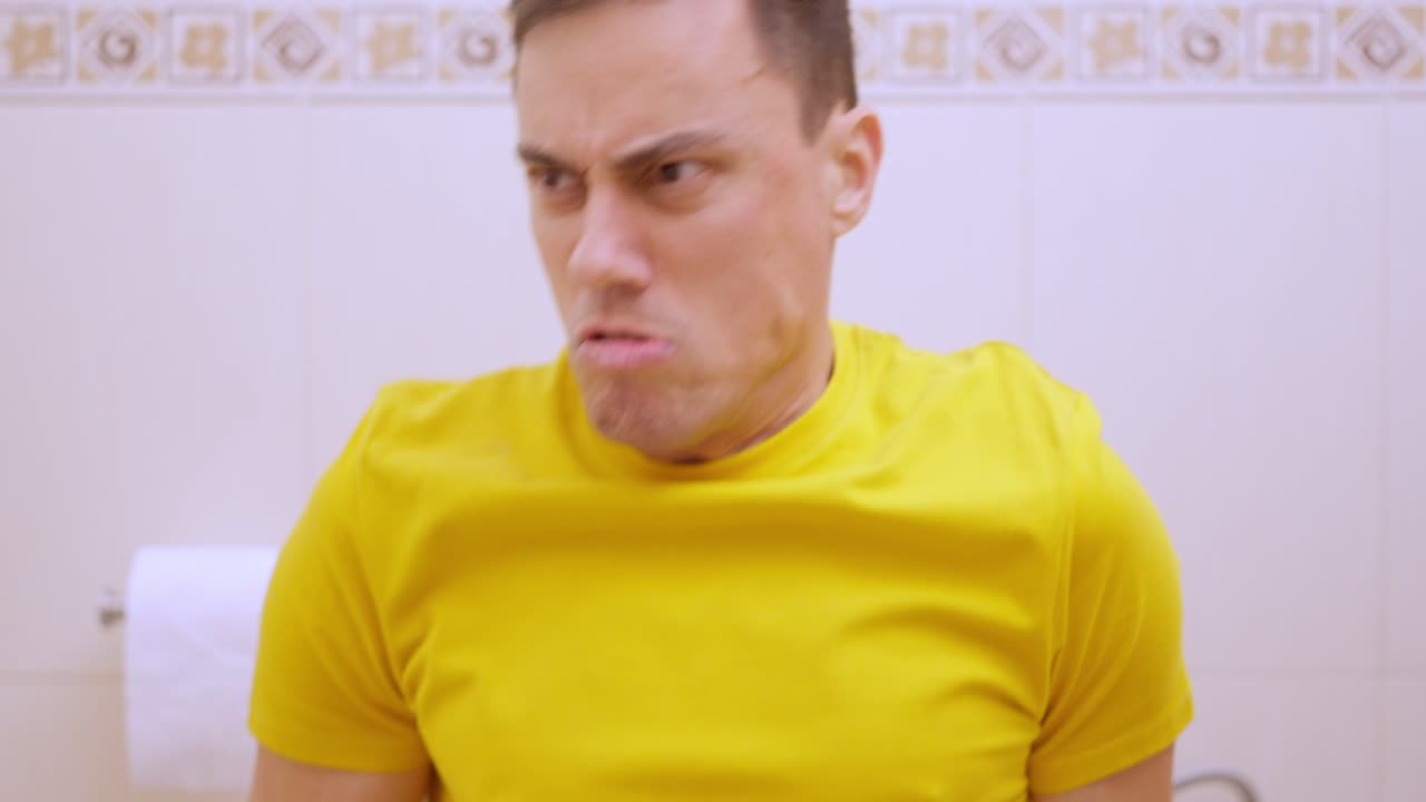 Man suffering from diarrhea using toilet paper in bathroom. Funny