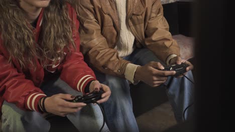 diverse friends playing video games on sofa