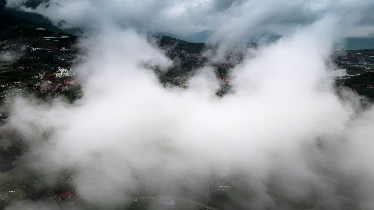 Aerial hyperlapse in patchy clouds above scenic Sapa in Northern Vietnam