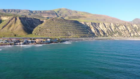 Aerial-shot-of-an-Amtrak-passenger-train-traveling-south-along-the-coast-of-Central-California-near-Santa-Barbara-Mussel-Shoals