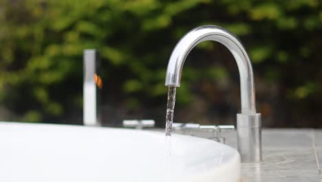 sequential frames showing water streaming from a tap