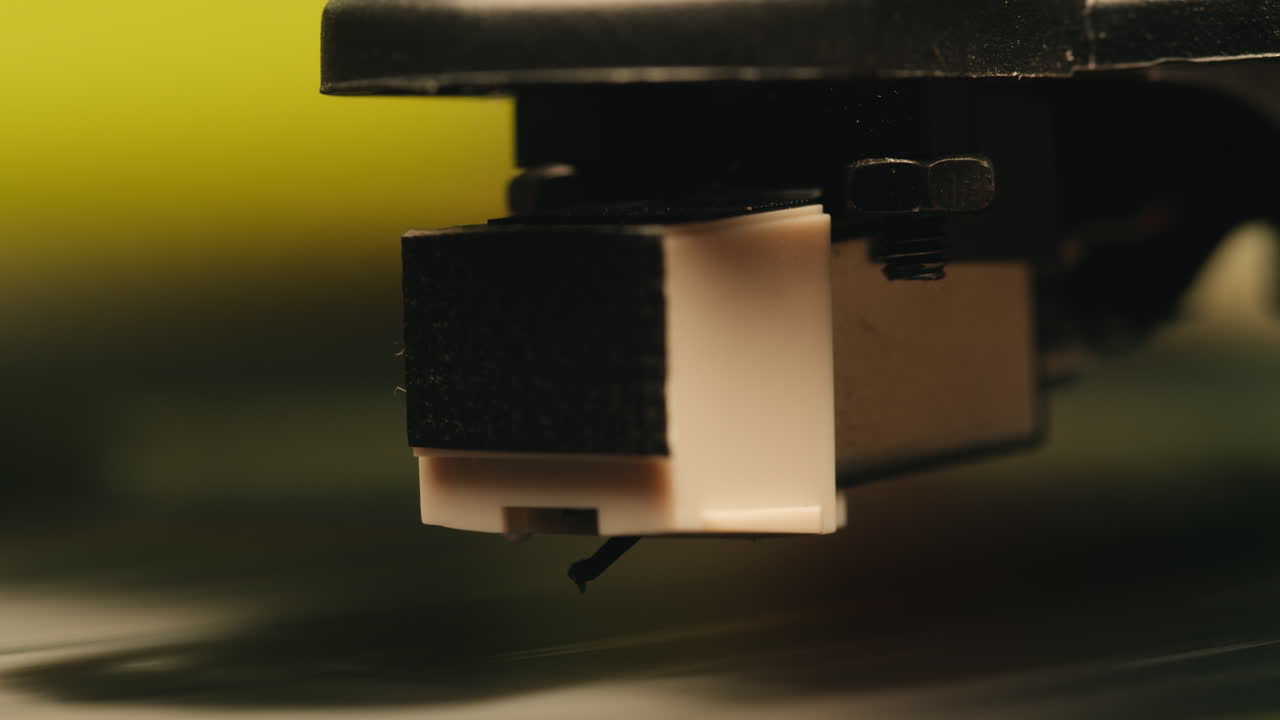Close-up de agulha de toca-discos sendo colocada em disco de vinil girando