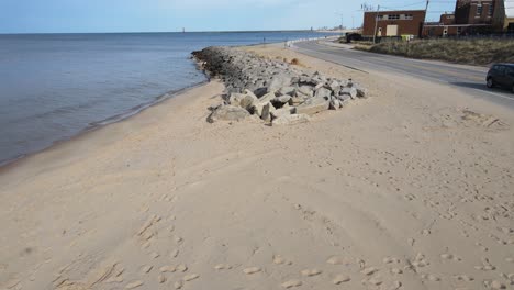 a drone track of the old stone reinforcements to hold back the sand dunes on lake michigan