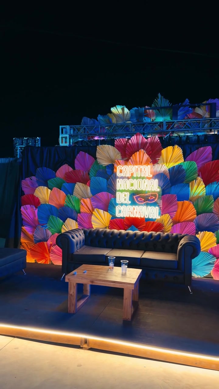 Festive Nighttime Lounge Decor with Colorful Paper Fans and Neon Sign