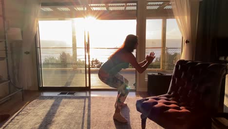 female working out inside house, sunset exercising, static view