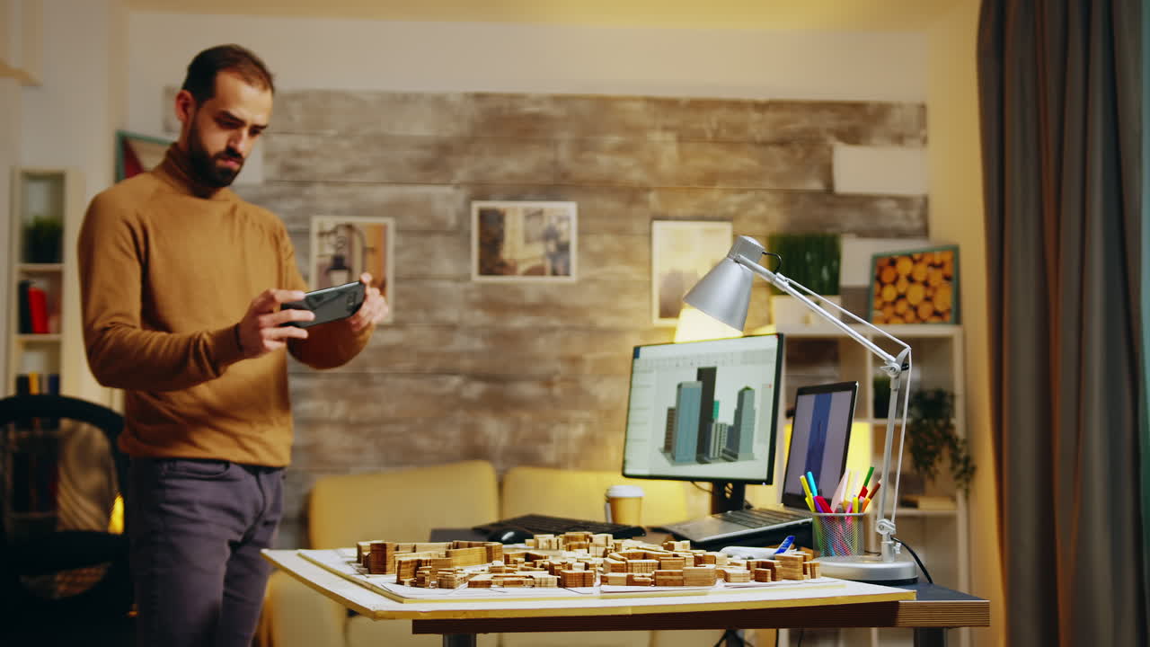 Successful architect taking photos with his phone