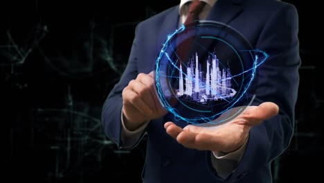 un hombre de negocios muestra un concepto de holograma de una ciudad inteligente en 3d en su mano.