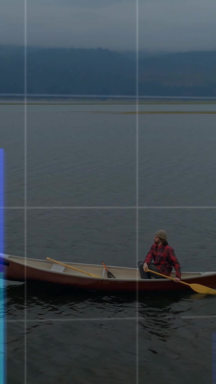 Vertical video: Man rowing canoe while tech overlay rising from right and covering canoe for data