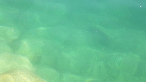 underwater view of rocks and clear water