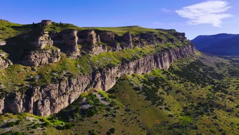 aerial view of a beautiful mountain range with blue skies and green foliage, in wyoming during the summer