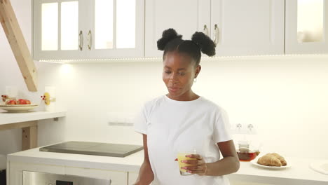 happy woman enjoying breakfast in the kitchen