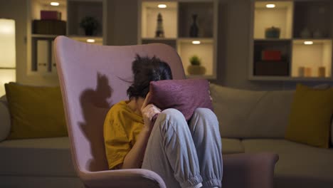 the young woman who presses the pillows on her head with fear.