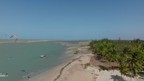 tropical lagoon with kitesurfer and boat near ilha do guajiura, ceará, brazil