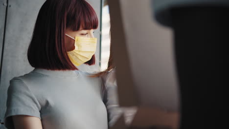 mother and daughter looking at a box while wearing masks