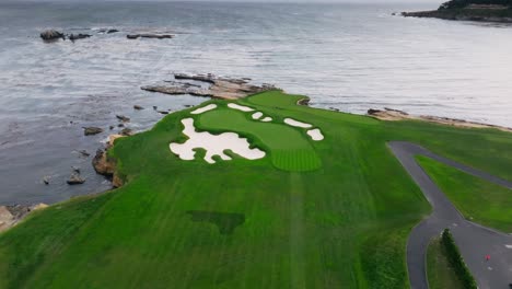 push in aerial drone shot of the 17th green at pebble beach golf links