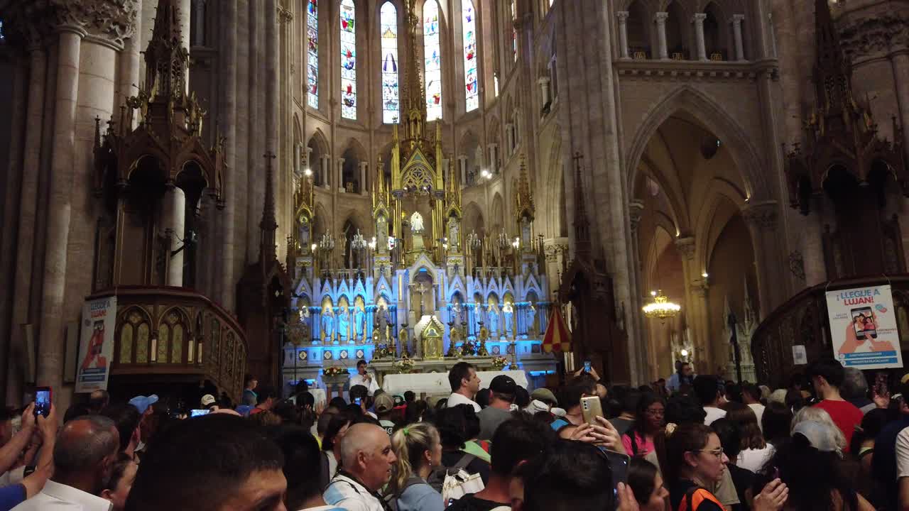 People pray inside Basilica of Our Lady of Luján catholic Virgin faith at Buenos Aires Argentina Procession