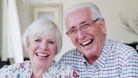 Happy-senior-couple-smiling-to-camera-at-home,-close-up