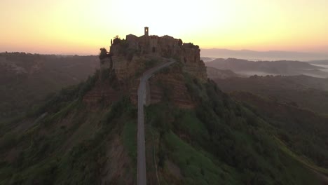 an aerial view shows civita di bagnoregio italy at sunset