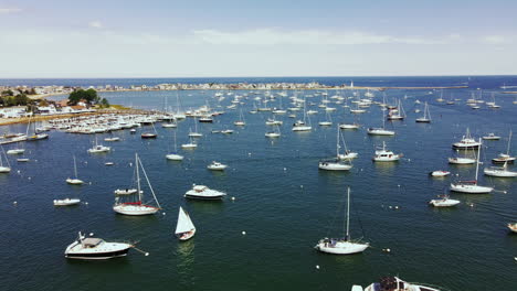 drone footage of scituate harbor in ma, low long push forward showing multiple boat and yachts