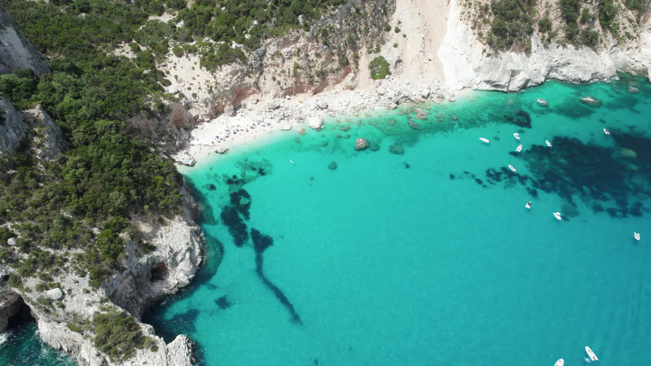 Aerial drone video of tropical paradise turquoise water and sea cliffs in the mediterranean, Cala Goloritz?