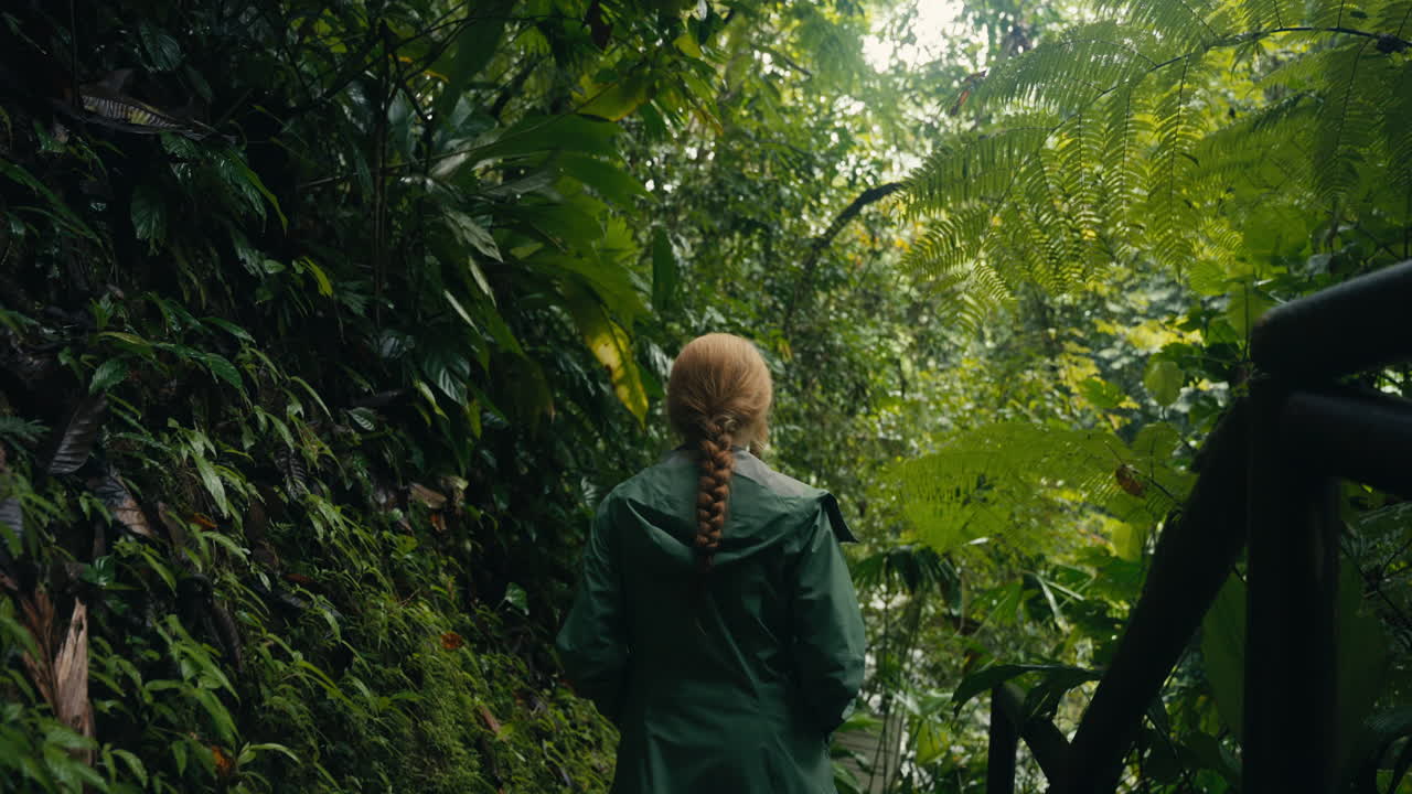 Woman walking through a lush jungle