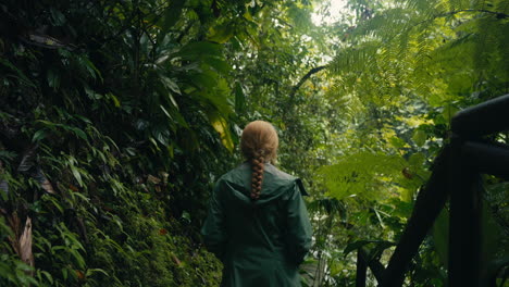 Woman walking through a lush jungle