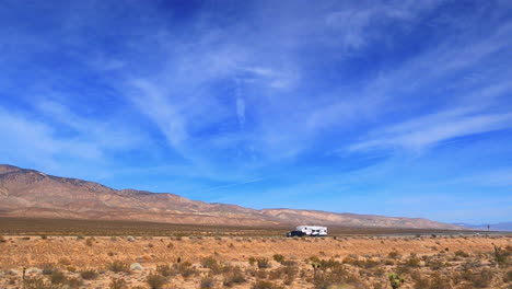 driving along a mojave desert road as the picturesque scenery scrolls by the passenger window