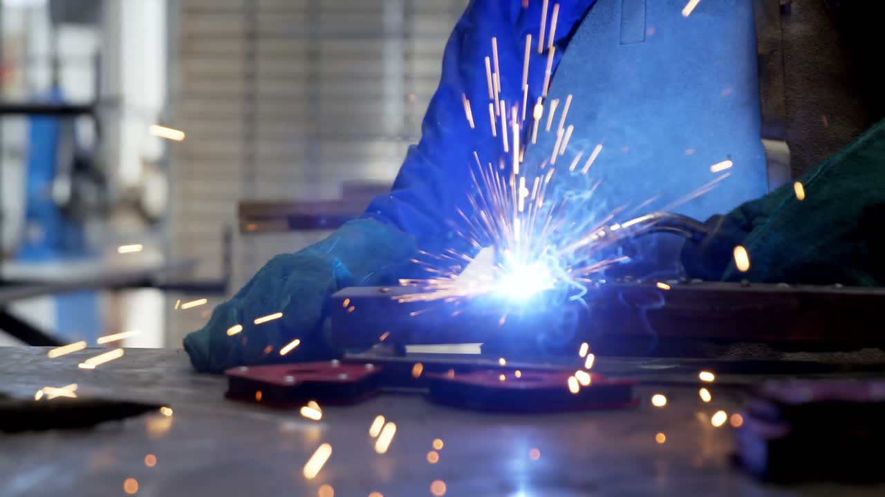 Female welder using blowing torch on a rod 4k