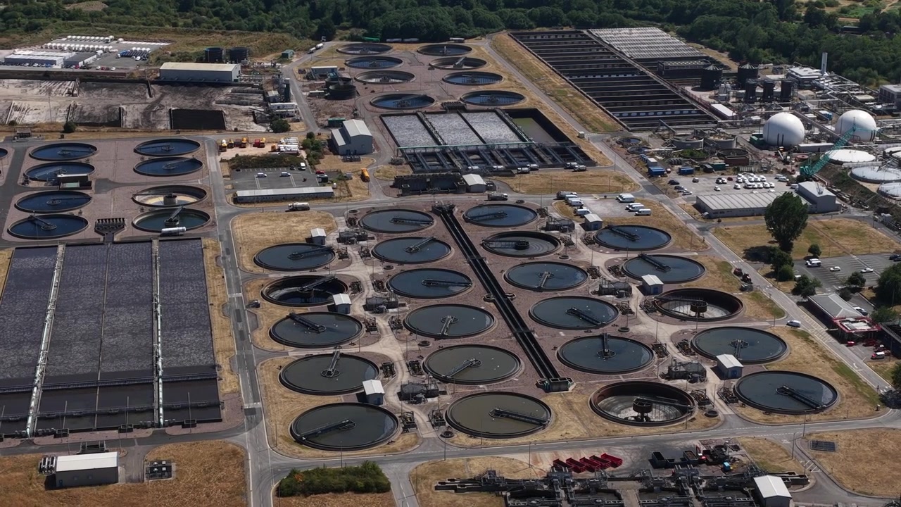 Aerial view of a wastewater treatment plant with settling tanks, filtration and biological processing used to clean sewage and safely discharge or reuse treated water.